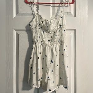 White romper with blue flowers